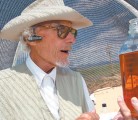 Calvin Hildebrand of Santa Fe, New Mexico, holds a measure of feed for his “ladies” in the tanks. The algae also get air, containing nitrogen, and bottled carbon dioxide. | Michael Raine photo