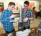 Yorkton Regional High School students Bo Chiasson and Jayden Leister work on their award winning robot designs. Interest in robotics has grown in their school. | Calvin Daniels photos