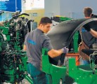 A tractor is dismantled piece by piece before a crowd of farmers in the Systems and Components Hall at Agritechnica in Hanover, Germany, earlier this month. | Michael Raine photo