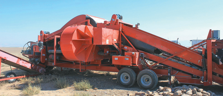 AirSep is a new approach to sorting clods and rocks from potatoes. By treating the perforated conveyor in the potato picker like sieves on a combine, air is added to gravity in the process of separating potatoes from other material. Grimme developed the new system, which allows farmers to reduce land preparation before seeding. | Agritechnica photo