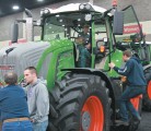 Agco’s Reid Hamre, left, discusses the new Fendt 900 series tractor with Kentucky farmers Tom and Allen Skinner during the National Farm Machinery Show. “The Fendt has many features that are optional on competing machines ... with much better resale values.” | Michael Raine photo