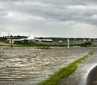 Flood water flows over a grid road on the south side of Highway 16, 3 Km. west of Foam Lake, Sask. | Robin Booker photo