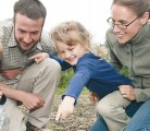 Donald and Amy Nikkel, with their children Alexis and Eli, check out oat seedlings coming up on Adagio Acres. | Robert Arnason photo
