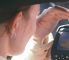 Christy Goldhawk uses an infrared thermography unit to check heat levels around the eyes of horses and bulls. The higher the body temperature, the greater the level of stress the animal is experiencing. | Barbara Duckworth photo